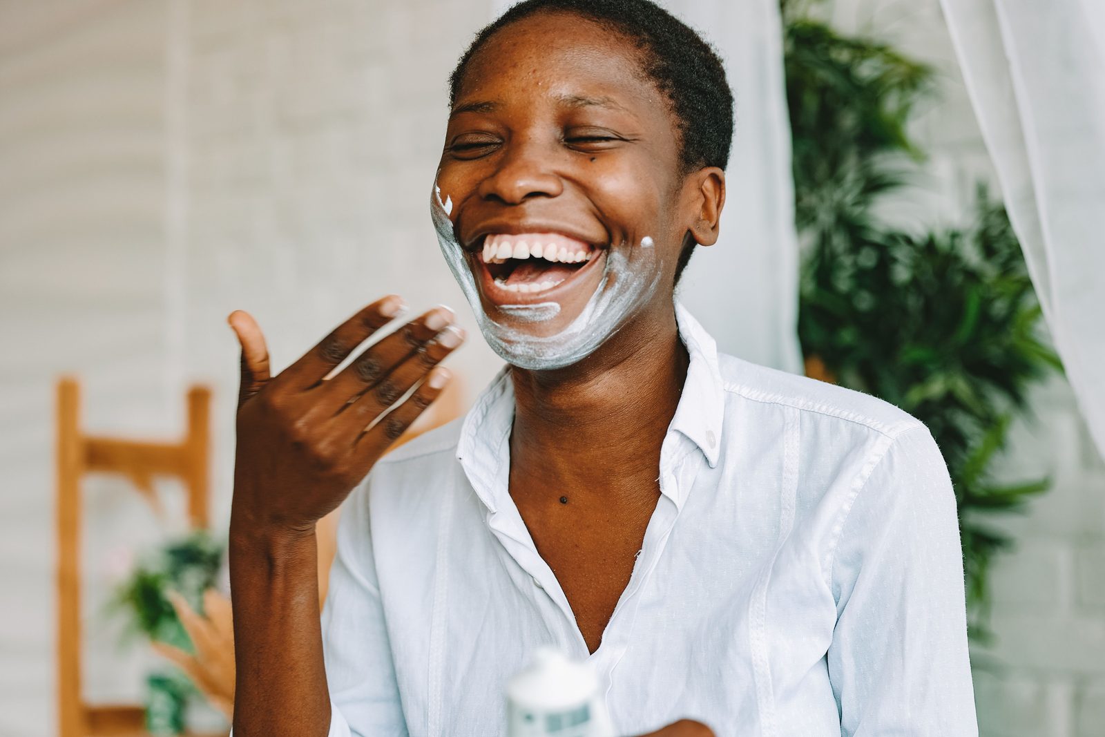 Woman smiling during a skincare routine