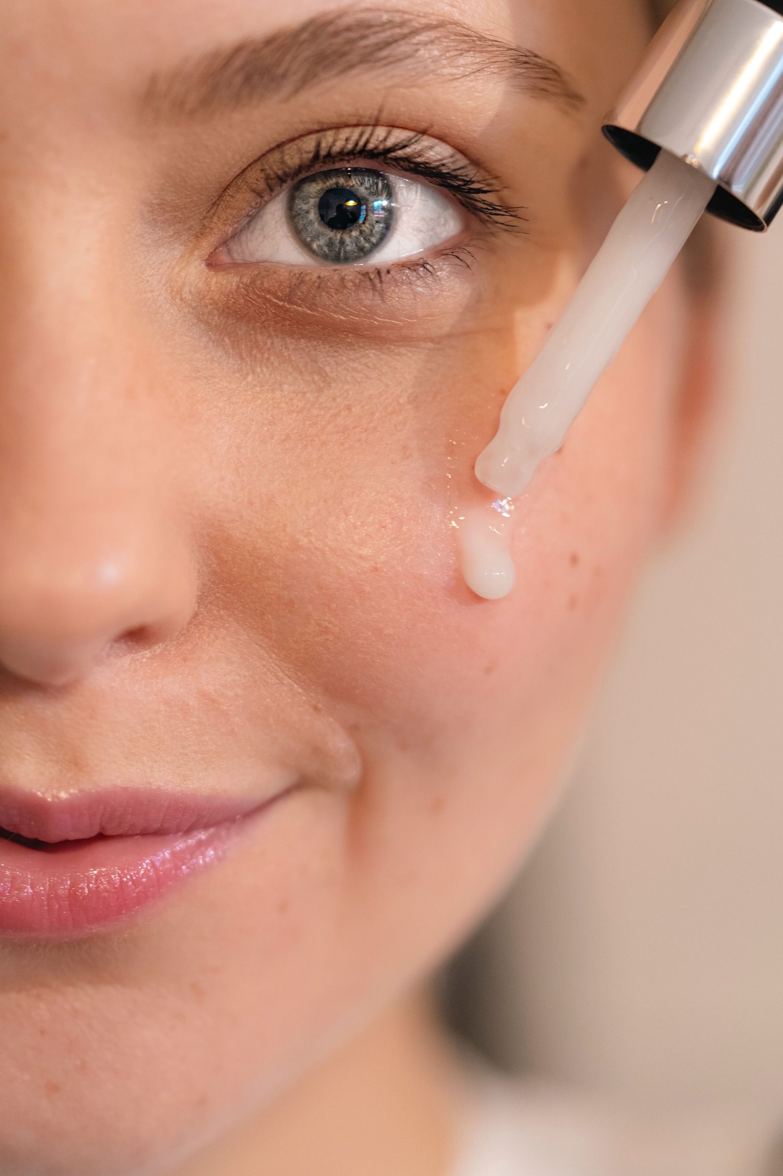 Close view of face serum being applied