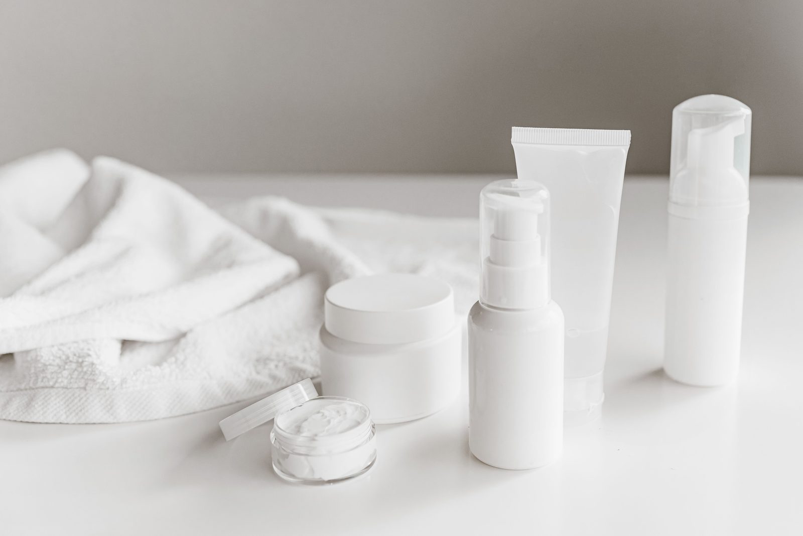 Minimal white skincare products arranged on a clean surface